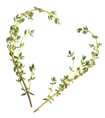 Fresh green thyme herb in shape of a heart falling in the air isolates on white background