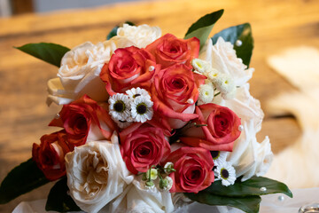 Flower shots on a wood table from a wedding pink white green and red