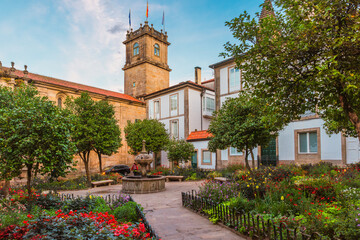 Small square in Santiago de Compostela city with flower garden and fountain, Galicia, Spain. Popular touristic landmark