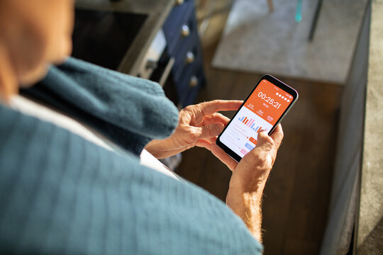 Man checking exercise stats on fitness app mobile phone