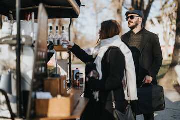 Two professionals having an informal meeting near a coffee cart on a bright and crisp winter day, evoking a sense of networking and collaboration. © qunica.com