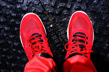 red pants and sneakers on a black background in high contrast