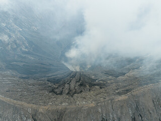 Aerial view of Mount Bromo crater filled with volcanic smoke
