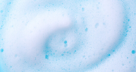 Foam swirl background. Liquid soap bubbles, Froth bubbles backdrop. Soap foam white backdrop. Soap sud macro structure close-up. Clean, cleaning, washing, laundry. Top view. 