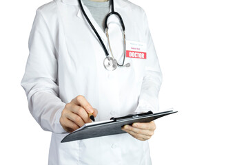 A female therapist in a white coat takes notes on a tablet on an isolated white background. Copy space, white background, stethoscope, medical care and examination, healthcare and treatment