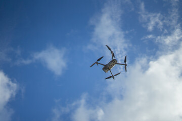 An unmanned aerial vehicle or quadcopter drone that flies with four rotors