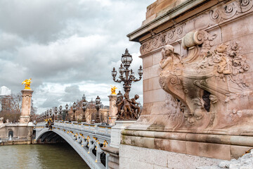 The Pont Alexandre III is a deck arch bridge that spans the Seine in Paris