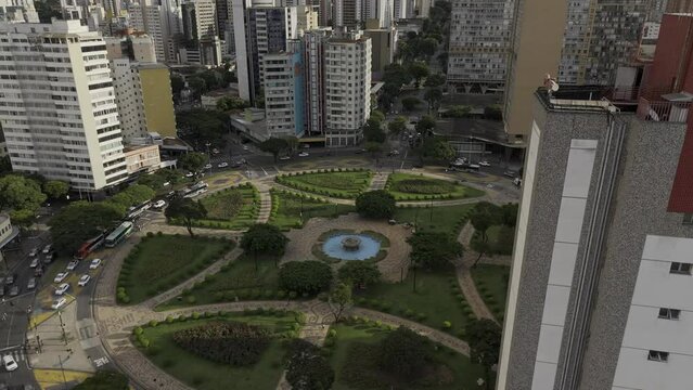 Drone descends at Pra&ccedil;a Raul Soares in Below Horizonte at sunset