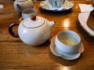 teapot and cups filled with green tea