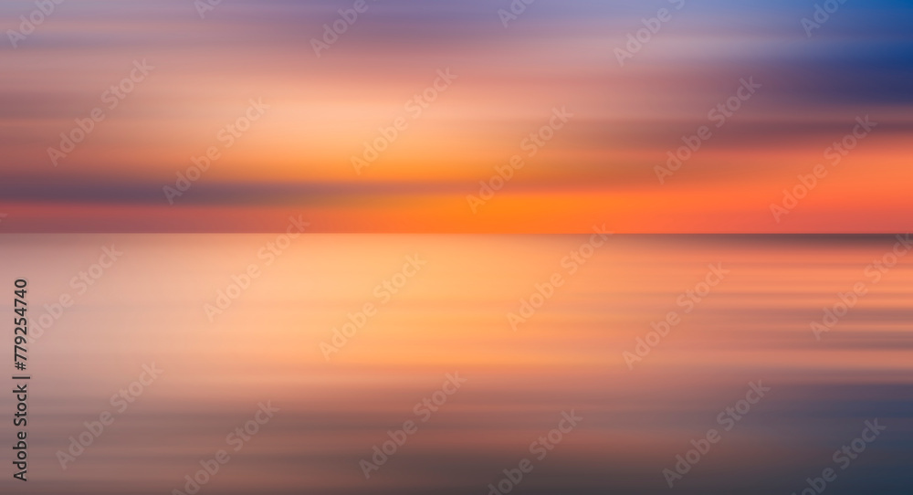 Poster abstract sun is setting over the ocean, casting warm glow on water. the sky is filled with clouds, c