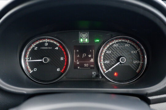 The dashboard of a car shows the speedometer at 120 mph. The gas gauge is green, indicating that the car has enough fuel to continue driving