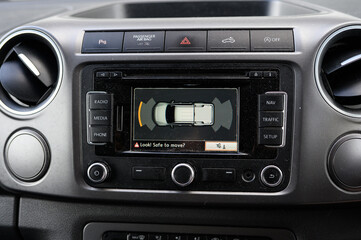 A car's dashboard shows a warning light and a message that says 