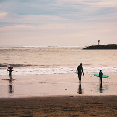 Fototapeta na wymiar Father taking sons winter surfing