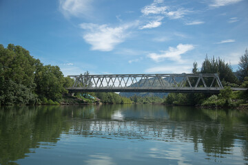 Fototapeta na wymiar Suspension bridge that stretches over the river