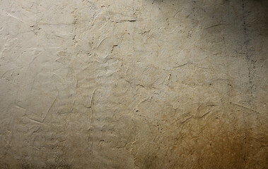 A wall with a lot of scratches and marks on it. The wall is made of concrete and has a rough texture