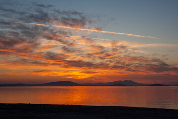 Sunset over Lake with mountains in the background. Beautiful sunset over lake.