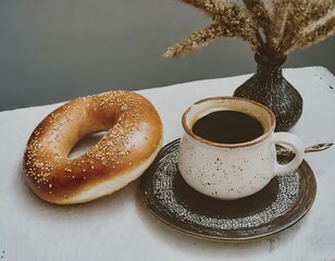 close-up photo of a vintage cup of coffee, a bagel, and a vase with plants