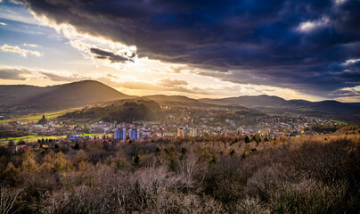 Dramatic cloudy sunset over Wałbrzych mountains in poland with city in the foreground