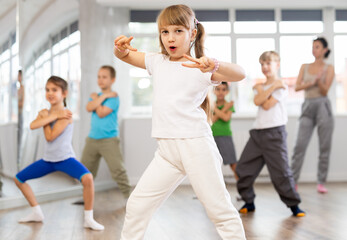 Group of boys and girls rehearsing hip hop dance in studio