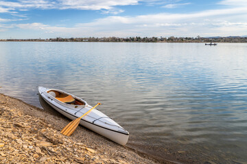 expedition decked canoe on a lake shore in early spring, Boedecker Reservoir in northern Colorado