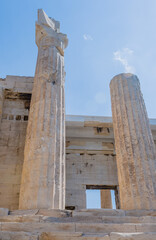 Ruined ancient Greek columns against a clear blue sky