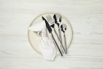 Stylish setting with elegant cutlery on white wooden table, top view