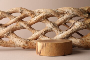 Presentation for product. Wooden podium and braided tree trunk on beige background