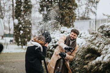 Joyful business colleagues having fun in snowy weather outdoors.