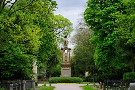 The historic melaten cemetery in cologne with a view of the central eagle column in springtime mood