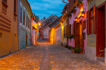 Fototapeta premium Colourful street in the old town of Sighisoara, Romania