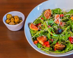 Vibrant fig and arugula salad with shaved parmesan