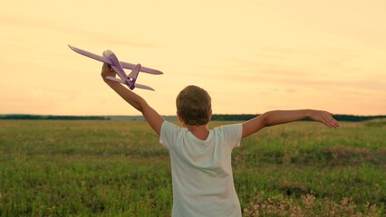 Child dream to fly. Kid, become an airplane pilot. Child flight dream concept. Happy boy child runs...