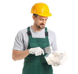 Male decorator with putty knife and plaster on white background