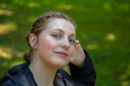 young beautiful redhead woman in a park student portrait outside