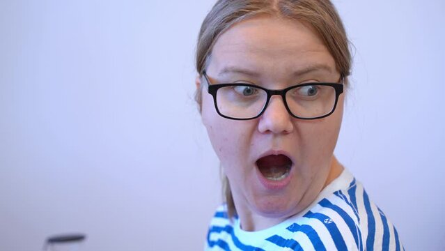 Portrait of woman in glasses reaction to surprise opens mouth, bulges her eyes, emotion of surprise is frozen from stress Mother face at children prank, emotional shock Win lottery, unexpected luck