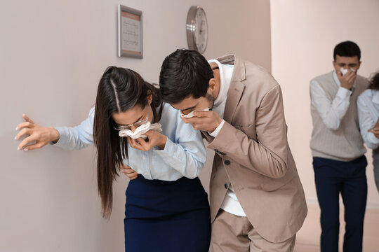 Business people with covered faces escaping from burning office building