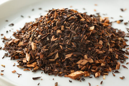 A closeup view of a pile of honey bush loose leaf tea.