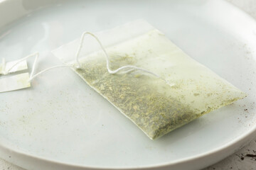 A view of a tea bag filled with green tea.