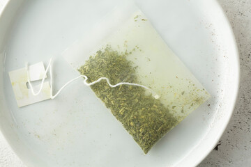 A top down view of a green tea bag.
