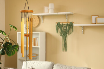Wind chime hanging in light living room, closeup