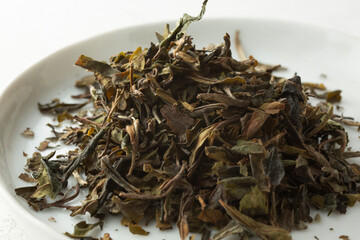 A closeup view of a pile of loose leaf kumaon white tea.