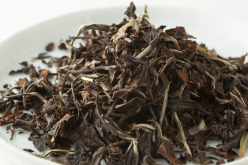 A closeup view of a pile of loose leaf Colombian white tea.