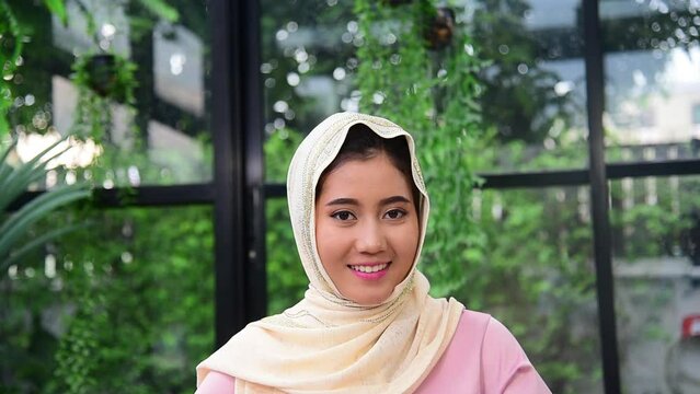 Muslim woman wear hijab smile face look at camera. Portrait Muslim women happy smiling face cheerful. Young Asian arabian middle eastern muslim people head scarf smiling confident attractive person