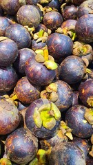 Close up pile of tasty fresh mangosteen sold at the market as a background.	
