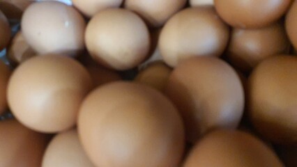 Close up of randomly stacked chicken eggs sold at the market as a background.	
