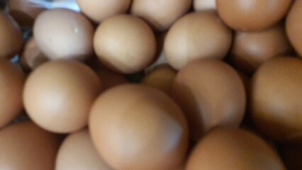 Close up of randomly stacked chicken eggs sold at the market as a background.	
