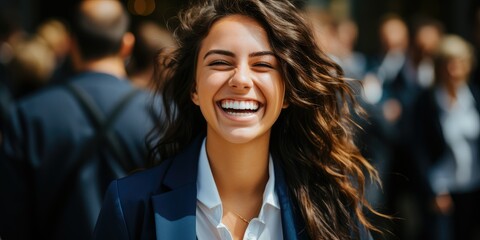 Obraz premium Laughing young woman entrepreneur with curly hair in city