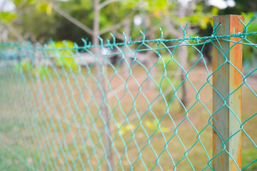 Solid metallic mesh fence closeup.