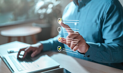 checklist, list, task, diagram, intelligence, management, marketing, touch, information, analysis. A man is using a laptop with a check mark on a virtual screen.