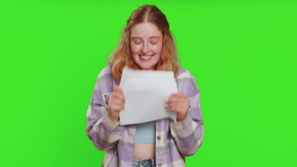 Young woman opens envelope take out letter reads it feel happy. Career growth advance promotion, bank loan approve, monetary award, long-awaited invitation great news. Redhead adult girl on chroma key